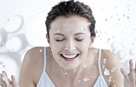 Woman washing her face