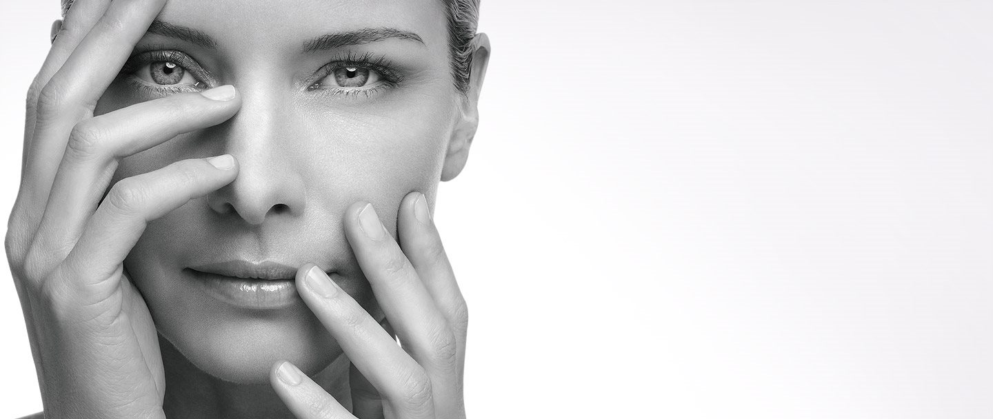 Woman holding up her hands in front of her face.